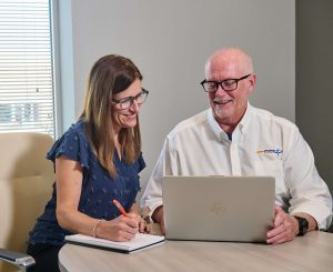 Two DocPoint employees viewing a laptop